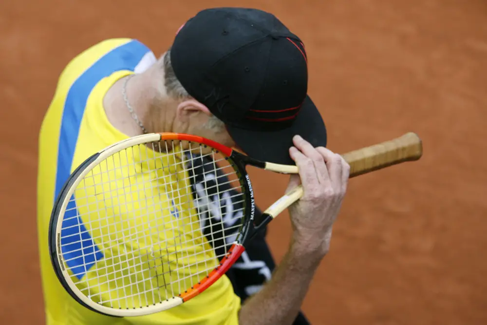 Tennis player touching his cap