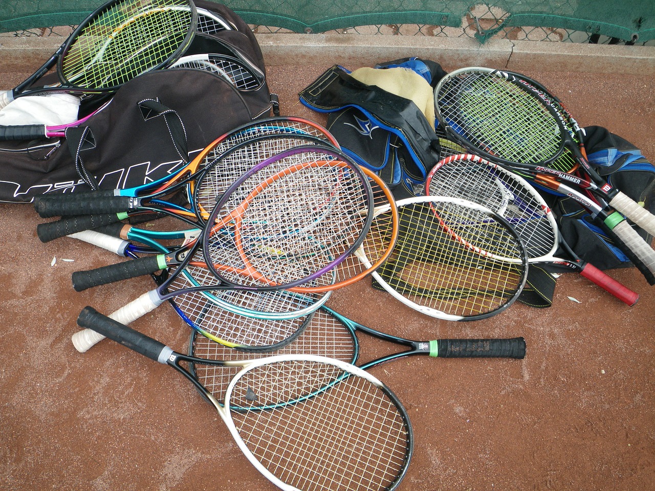 many tennis racekts on the floor