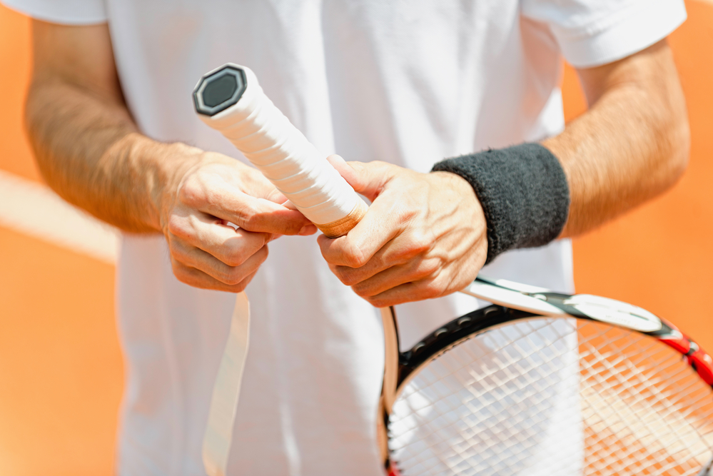 Wrapping tennis racket with an overgrip