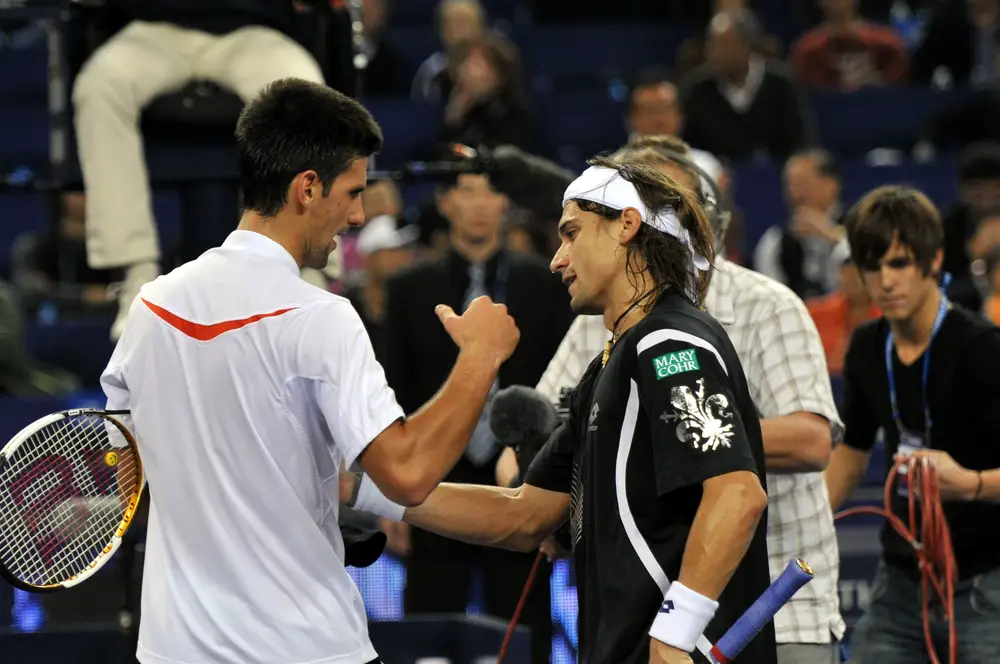 David Ferrer of Spain, right, shakes hands with Novak Djokovic