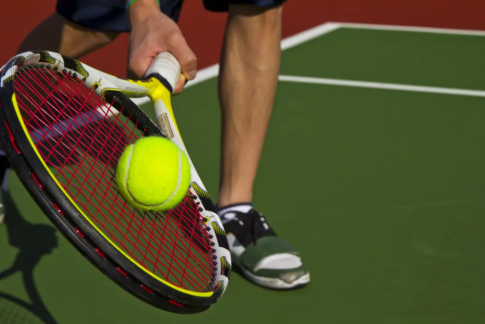 tennis player hits the ball