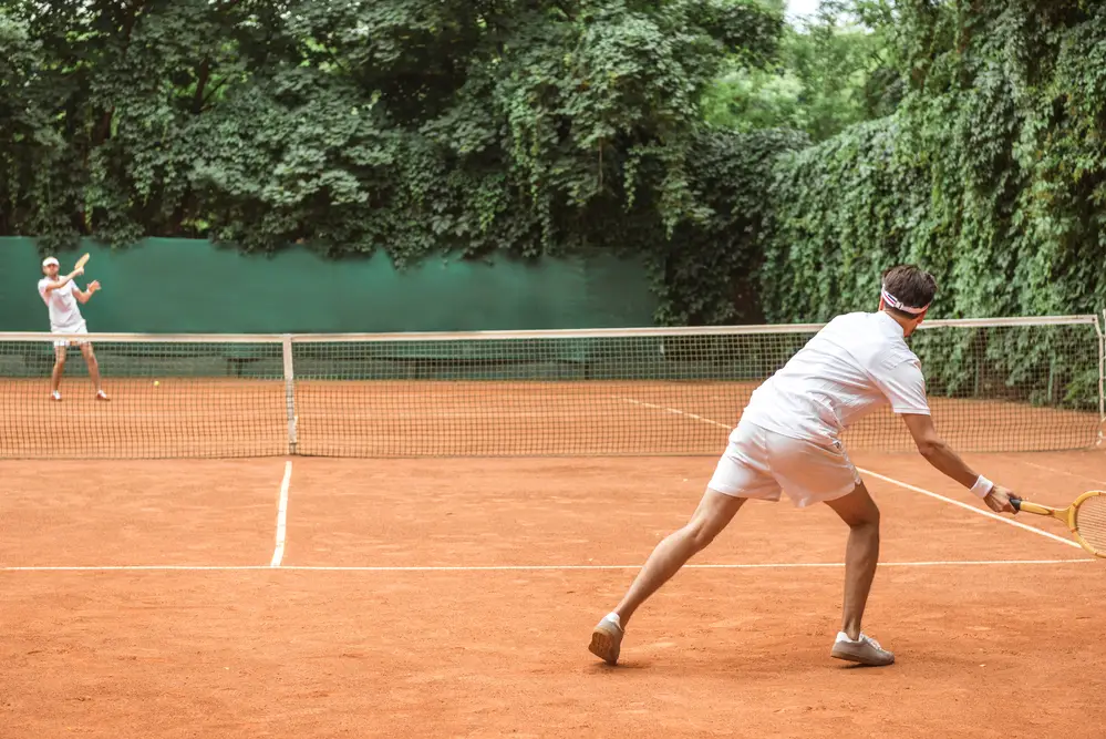 Two tennis players playing cross court